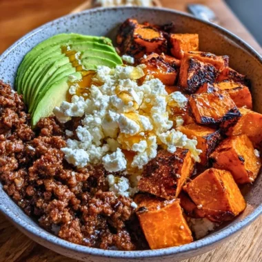 Protein Hot Honey Beef Bowl with 45g protein garnished with spicy sauce and herbs