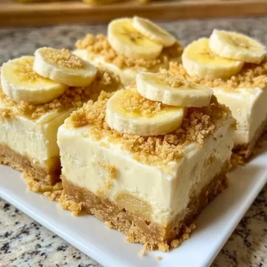 Delicious banana pudding cheesecake squares served in a dessert dish