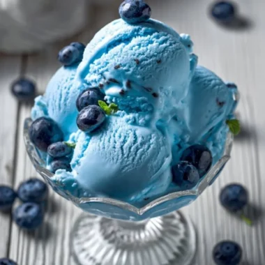 A bowl of homemade Blue Moon ice cream with a bright blue color and creamy texture.