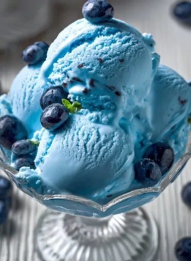 A bowl of homemade Blue Moon ice cream with a bright blue color and creamy texture.