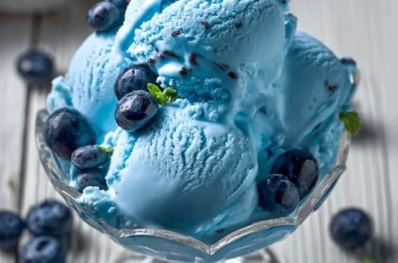 A bowl of homemade Blue Moon ice cream with a bright blue color and creamy texture.