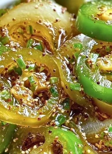 Bread and Butter Jalapeño Pickles in a jar with fresh jalapeños and spices