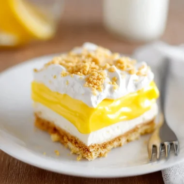 Slice of heavenly Oreo lemon dessert with crispy crust and lemon cream filling
