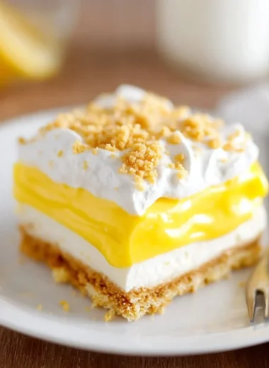 Slice of heavenly Oreo lemon dessert with crispy crust and lemon cream filling