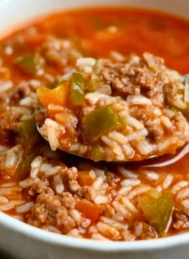 Delicious bowl of stuffed pepper soup with colorful peppers and herbs