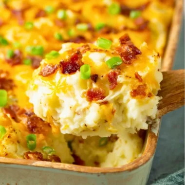 Twice baked potato casserole served in a baking dish with toppings