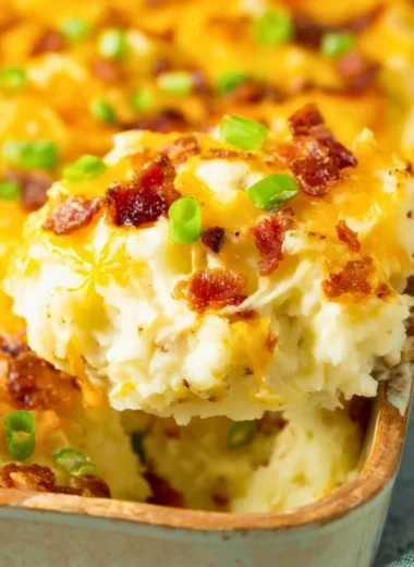 Twice baked potato casserole served in a baking dish with toppings