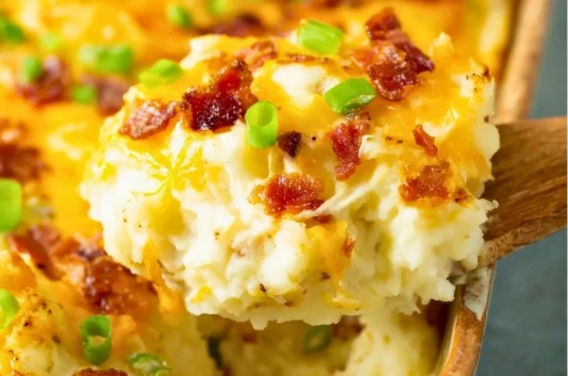 Twice baked potato casserole served in a baking dish with toppings
