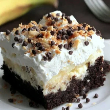 A delicious Chocolate Banana Poke Cake topped with chocolate and banana slices.