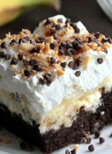 A delicious Chocolate Banana Poke Cake topped with chocolate and banana slices.