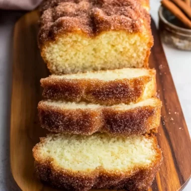 Freshly baked cinnamon sugar donut bread on a wooden table