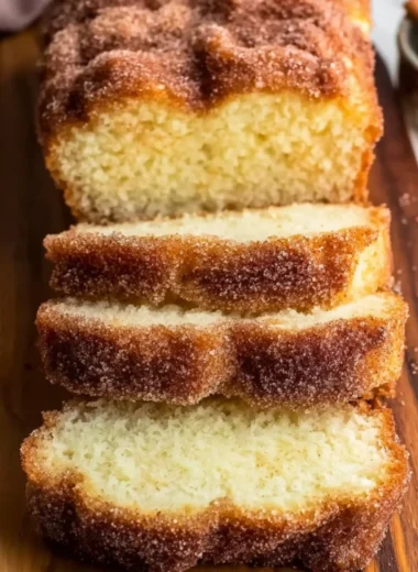 Freshly baked cinnamon sugar donut bread on a wooden table