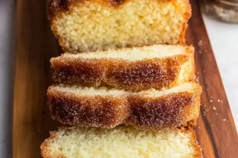 Freshly baked cinnamon sugar donut bread on a wooden table
