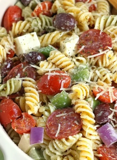 Classic pasta salad with colorful vegetables and dressing served in a bowl