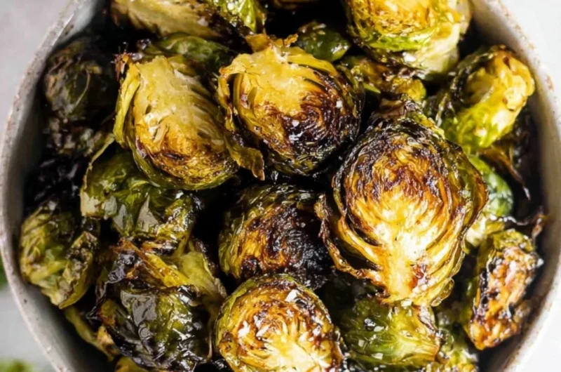 Crispy oven roasted brussel sprouts with balsamic glaze on a serving plate