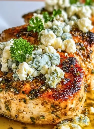 Plate of Greek Chicken with Lemon and Feta garnished with herbs