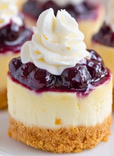 Healthy mini lemon blueberry cheesecakes topped with fresh blueberries
