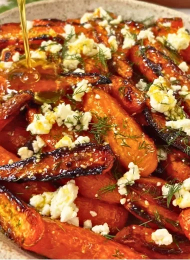 Honey garlic roasted carrots topped with feta cheese, a flavorful side dish.