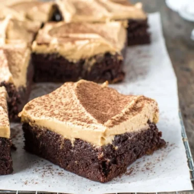 Mocha brownies topped with cafe latte frosting on a plate