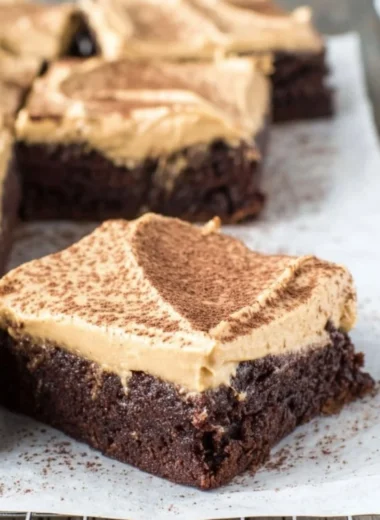 Mocha brownies topped with cafe latte frosting on a plate