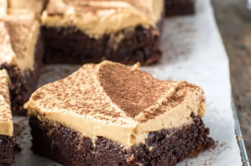 Mocha brownies topped with cafe latte frosting on a plate