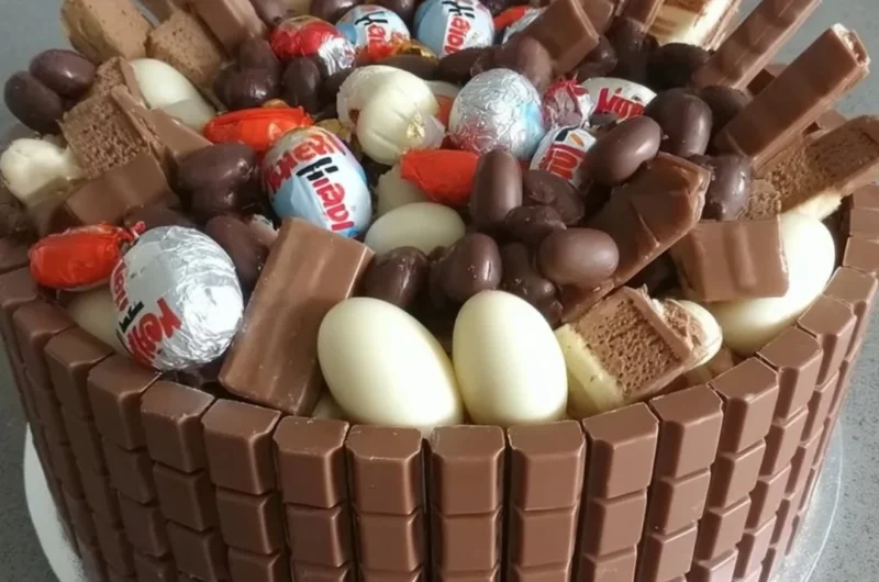 Delicious No-Bake Kinder Chocolate Cake topped with chocolate and Kinder chocolate bars