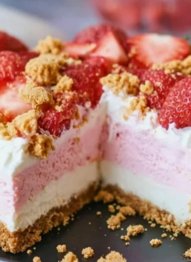 Delicious no-bake strawberry crunch cheesecake with a crumbly topping.