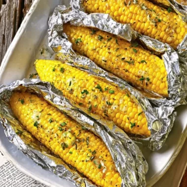 Oven-roasted corn on the cob served with butter and herbs