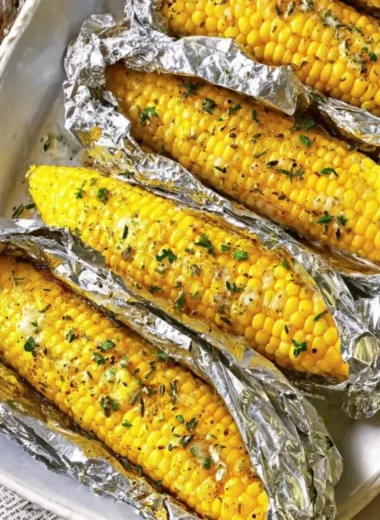 Oven-roasted corn on the cob served with butter and herbs