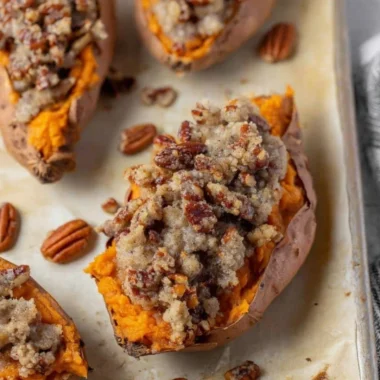 Pecan Pie Twice Baked Sweet Potatoes garnished with nuts and caramel drizzle.