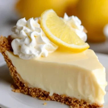 Delicious lemon pie topped with whipped cream and lemon zest.