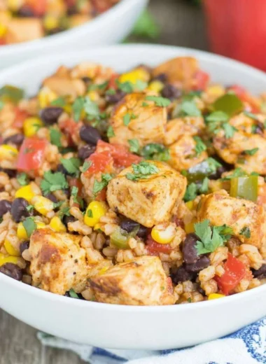 Delicious Southwest chicken and rice bowl topped with fresh garnishes