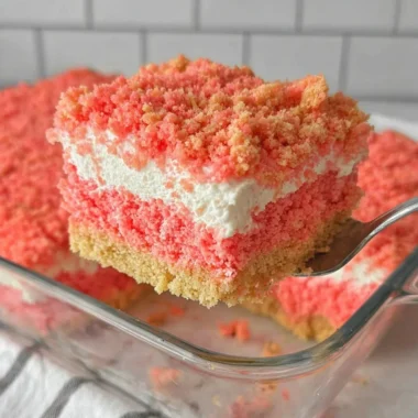 Delicious Strawberry Crunch Cake topped with strawberry flakes and whipped cream