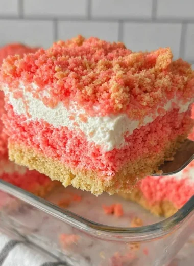 Delicious Strawberry Crunch Cake topped with strawberry flakes and whipped cream