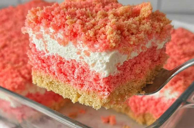 Delicious Strawberry Crunch Cake topped with strawberry flakes and whipped cream