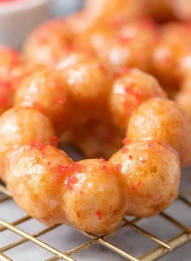 Delicious gluten-free mochi donuts with colorful toppings on a plate