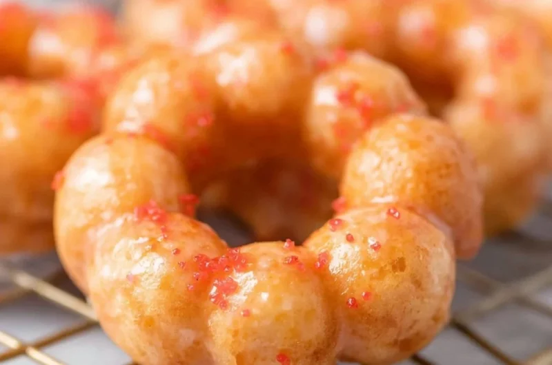 Delicious gluten-free mochi donuts with colorful toppings on a plate