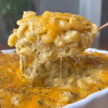 Bowl of spicy Buffalo Mac and Cheese topped with cheese and herbs
