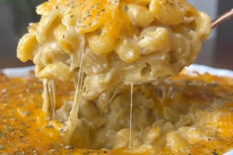 Bowl of spicy Buffalo Mac and Cheese topped with cheese and herbs