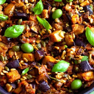 Plate of traditional Sicilian Caponata with eggplant, tomatoes, and olives