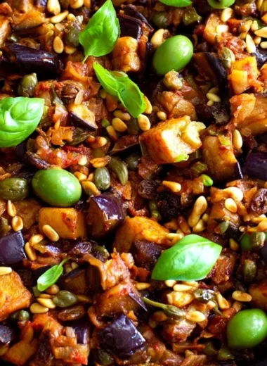 Plate of traditional Sicilian Caponata with eggplant, tomatoes, and olives