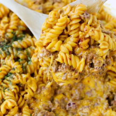 Creamy beef rotini pasta dish served in a bowl with herbs