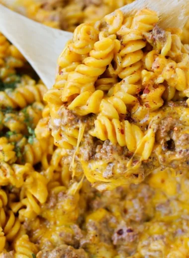 Creamy beef rotini pasta dish served in a bowl with herbs