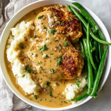Creamy garlic chicken dish served with herbs and spices on a plate.