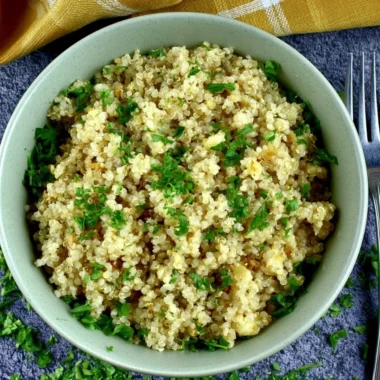 Delicious bowl of Garlic Butter Quinoa garnished with fresh herbs