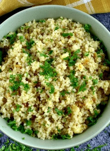 Delicious bowl of Garlic Butter Quinoa garnished with fresh herbs