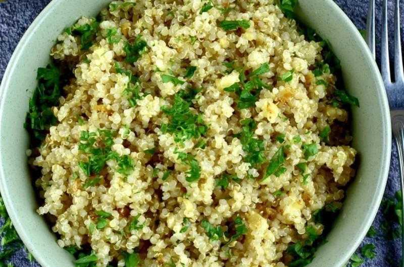 Delicious bowl of Garlic Butter Quinoa garnished with fresh herbs