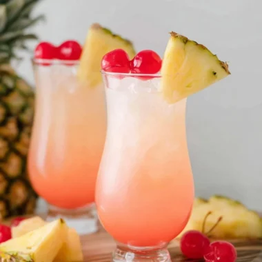 Malibu Bay Breeze cocktail garnished with a slice of pineapple and cherry