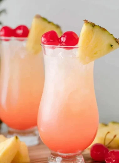 Malibu Bay Breeze cocktail garnished with a slice of pineapple and cherry