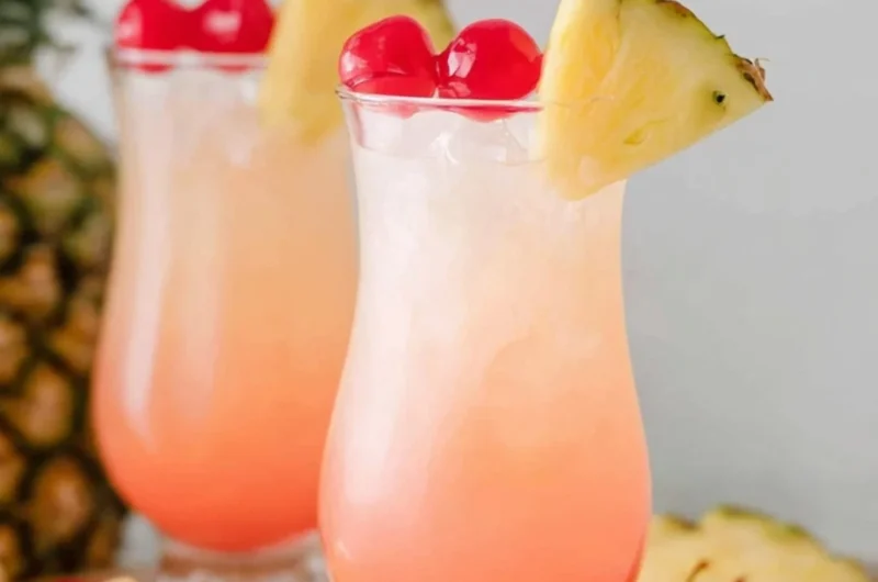Malibu Bay Breeze cocktail garnished with a slice of pineapple and cherry